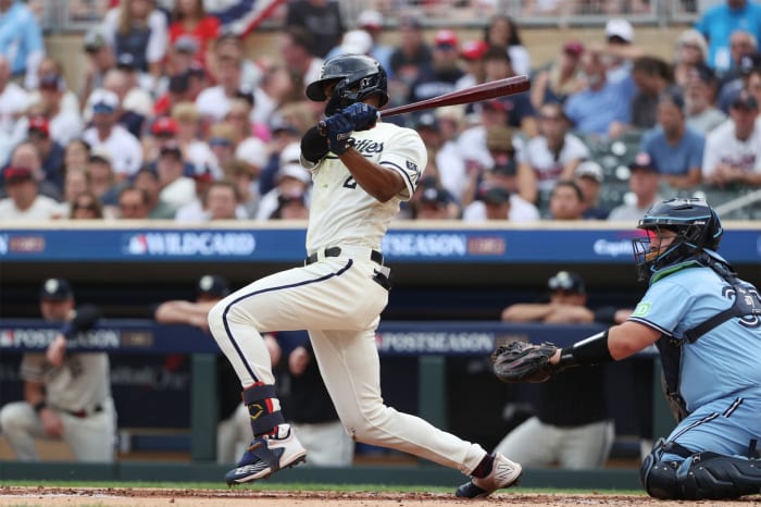 Oct 3, 2023; Minneapolis, Minnesota, USA; Minnesota Twins center fielder Michael A. Taylor (2) hits a single in the second inning against the Toronto Blue Jays during game one of the Wildcard series for the 2023 MLB playoffs at Target Field. Mandatory Credit: Jesse Johnson-USA TODAY Sports